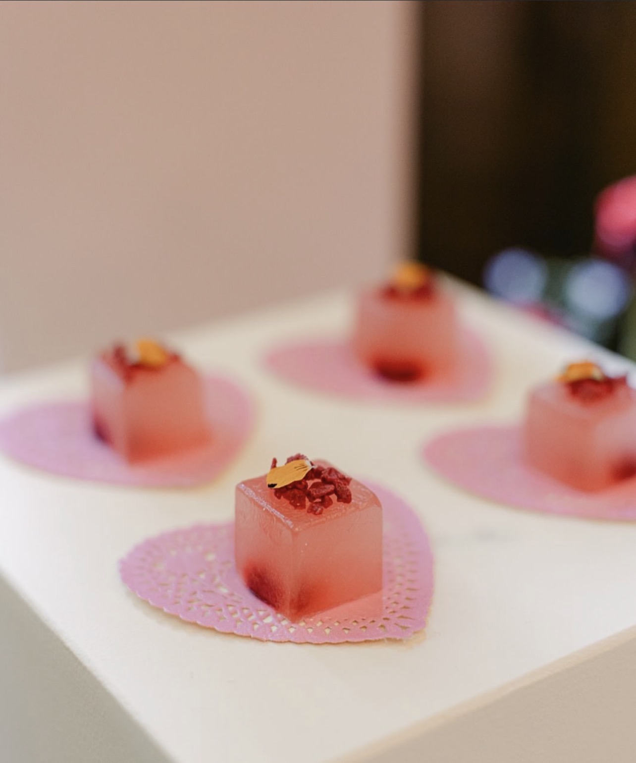 Rosé jellies arranged on pale doilies